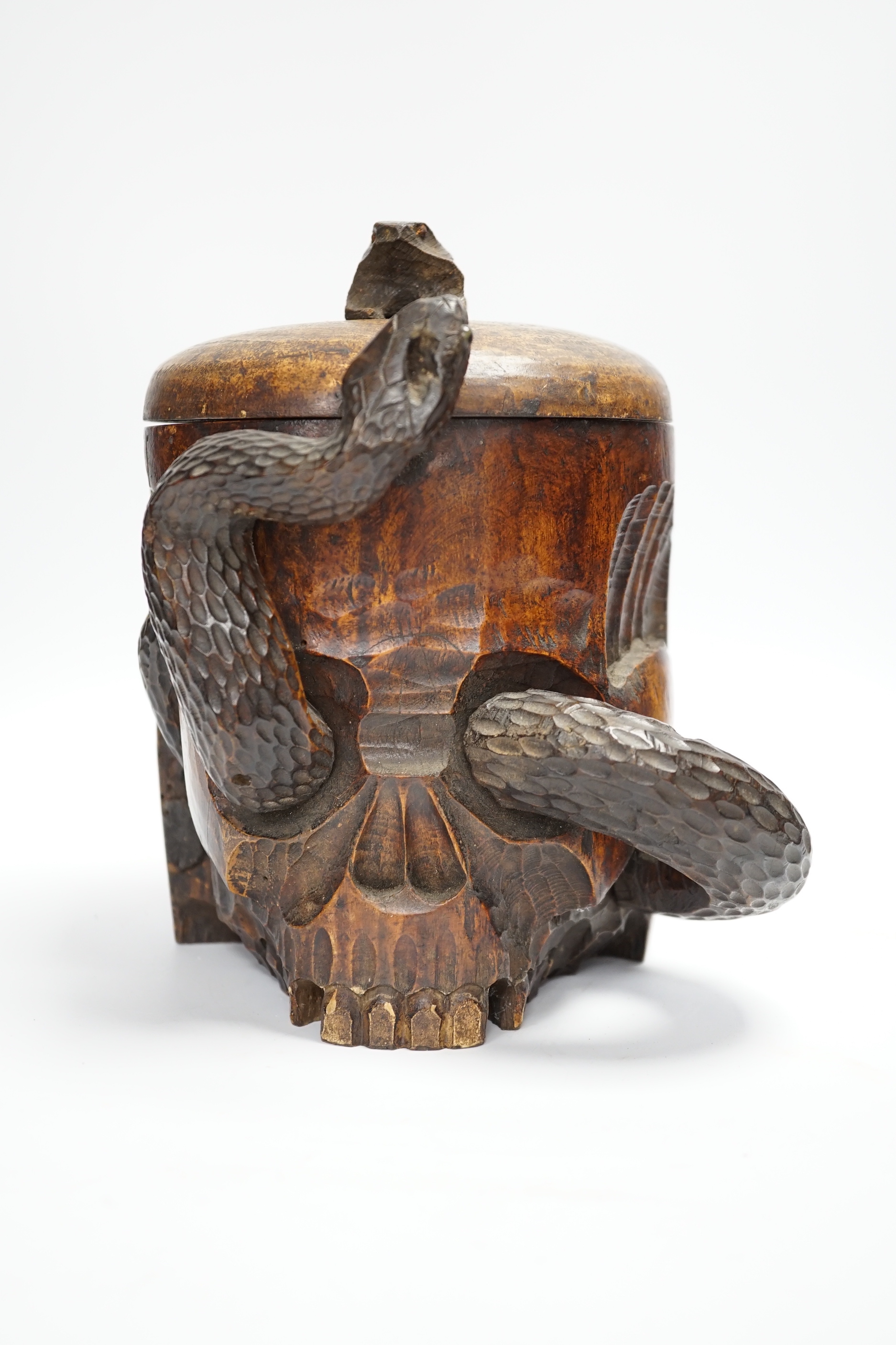 A Japanese carved wood tobacco jar in the form of a skull and snake, Meiji period, 21cm high